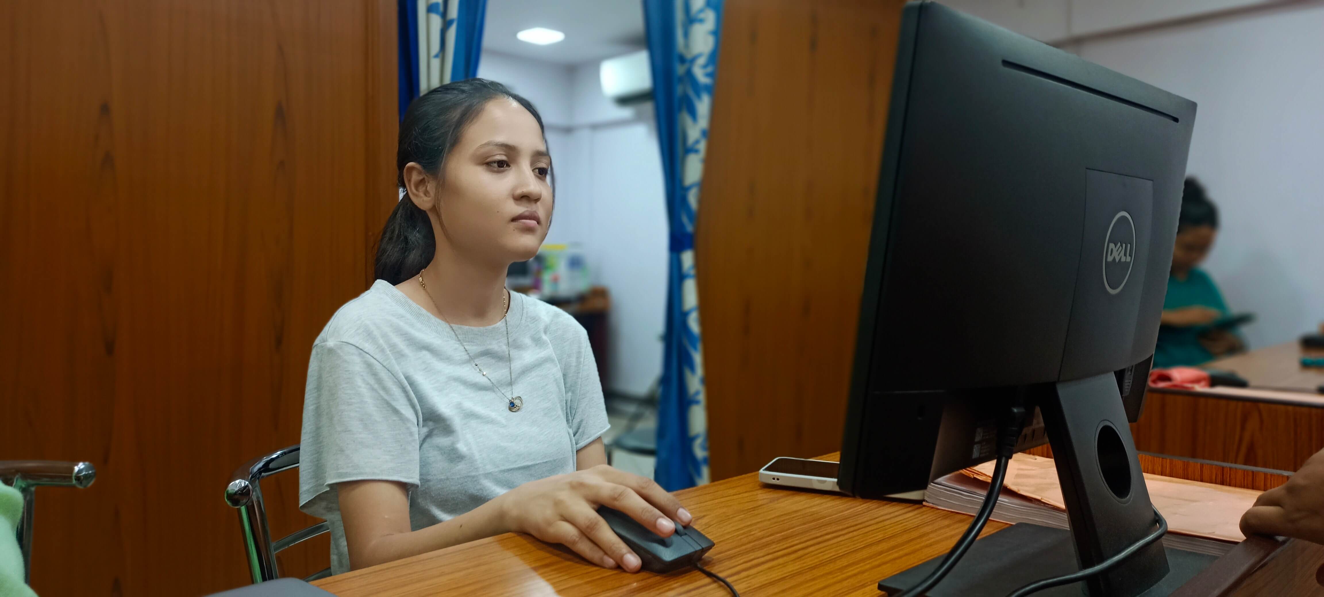 Bengali medium intern working at computer